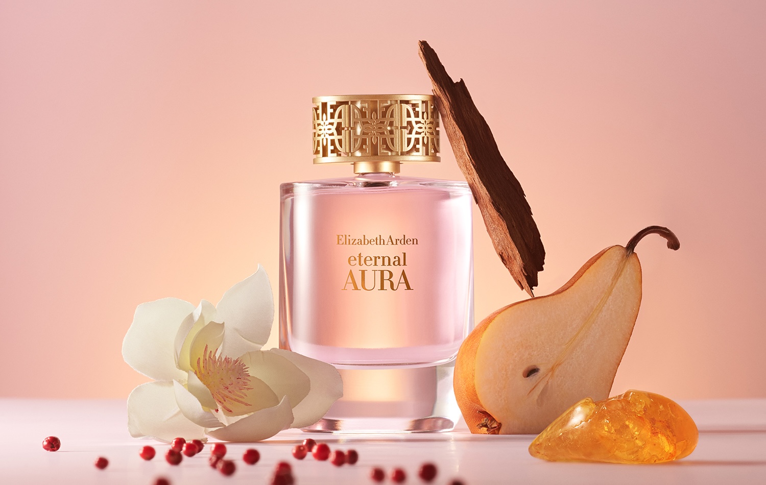 Eternal Aura Eau de Parfum bottle with magnolia petals and amber resin